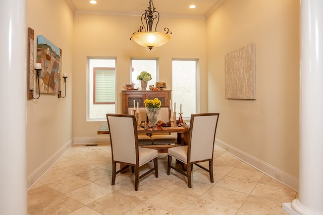 dining area with ornate columns and ornamental molding