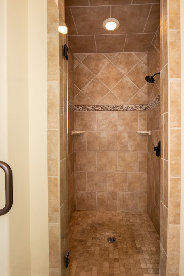 bathroom with a shower with door