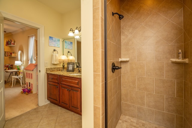 bathroom with an enclosed shower, vanity, and tile patterned floors