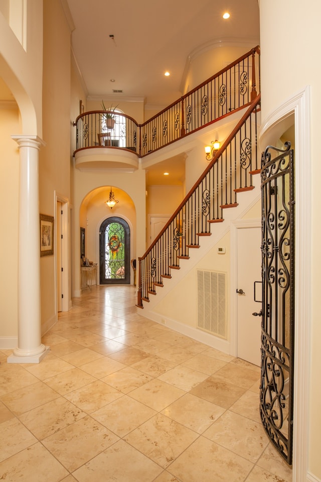 entrance foyer with a high ceiling and ornate columns