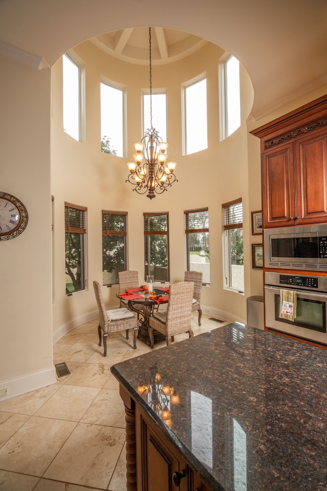 interior space featuring a wealth of natural light, a high ceiling, and light tile patterned floors