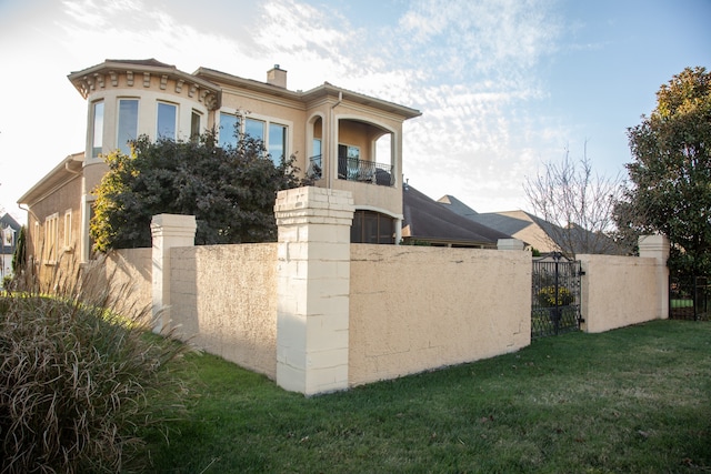 view of front of property with a front lawn and a balcony