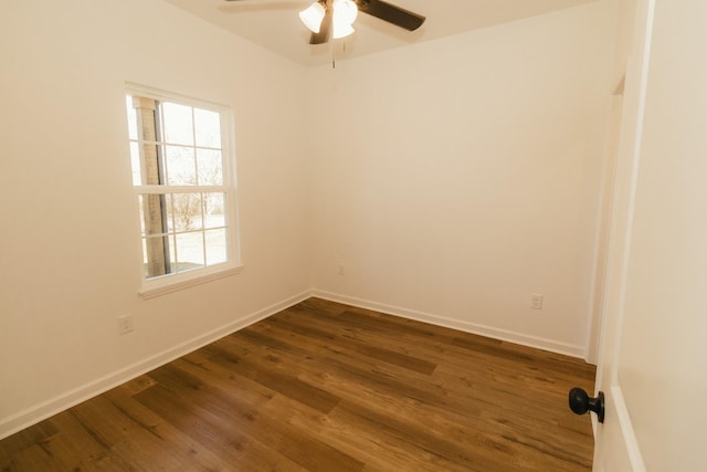 spare room featuring dark hardwood / wood-style flooring and ceiling fan