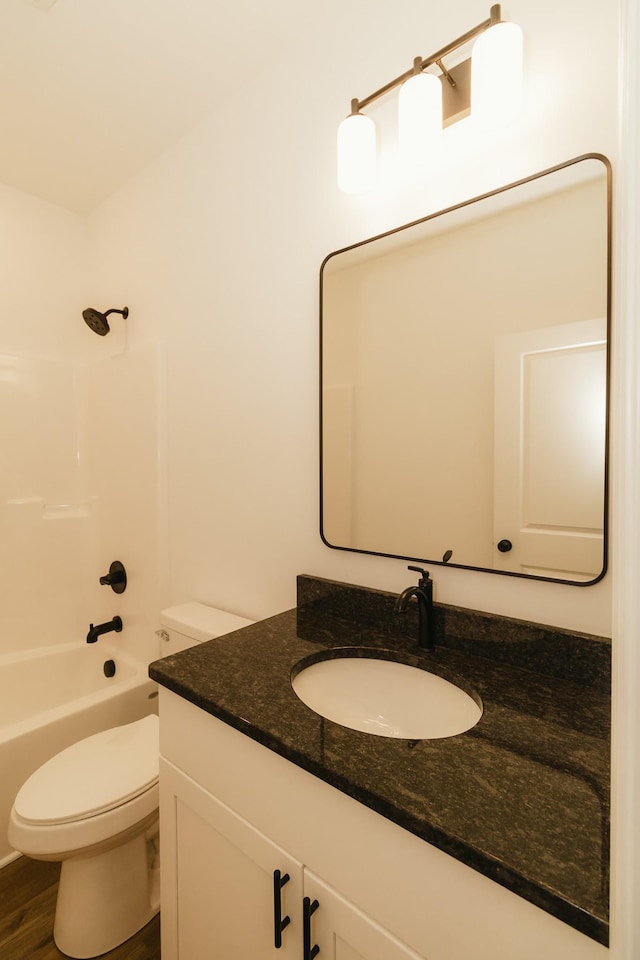 full bathroom featuring hardwood / wood-style floors, vanity, shower / bath combination, and toilet