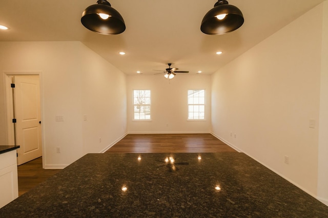 empty room featuring ceiling fan and dark wood-type flooring