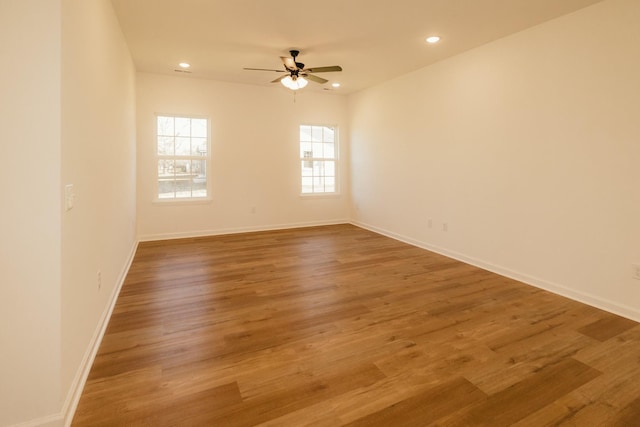 empty room featuring ceiling fan and hardwood / wood-style flooring