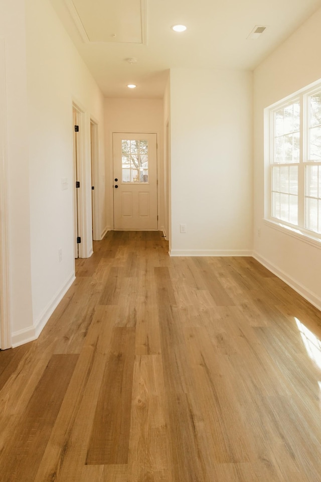 hall with light hardwood / wood-style flooring