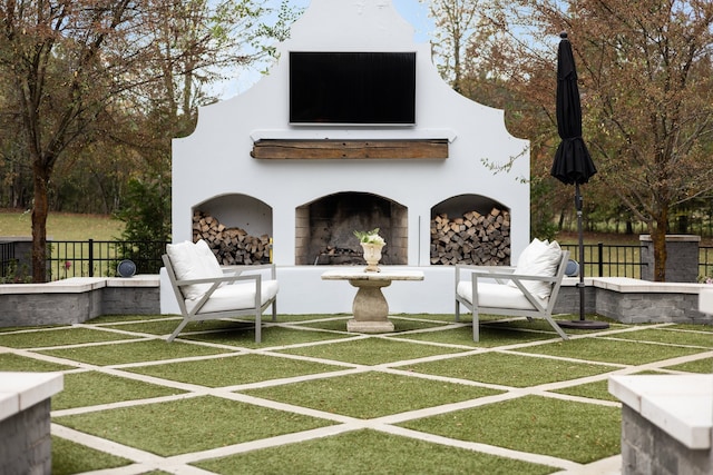 exterior space with a lawn and an outdoor fireplace