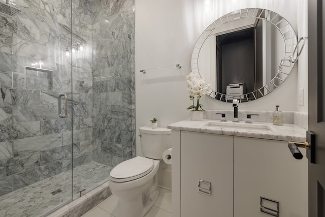 bathroom featuring a shower with door, vanity, and toilet