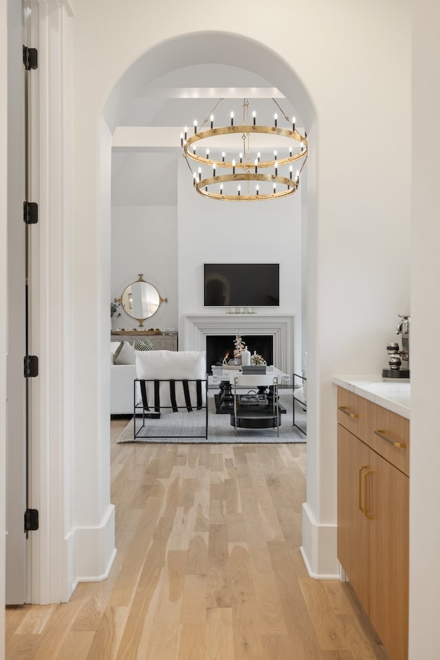 corridor featuring light hardwood / wood-style floors and a chandelier