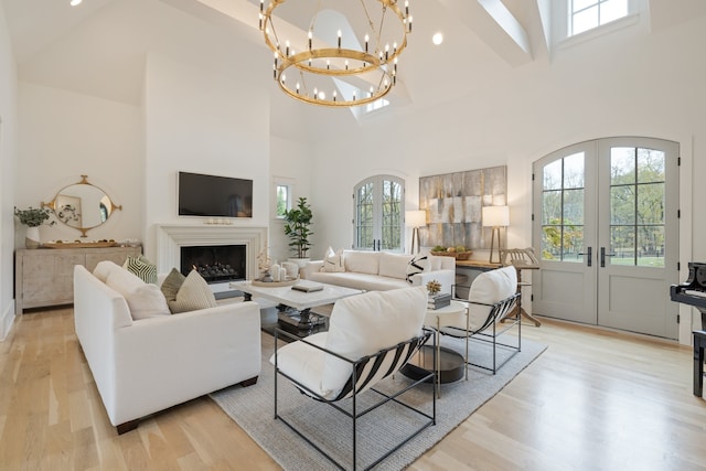 living room with high vaulted ceiling and light hardwood / wood-style flooring