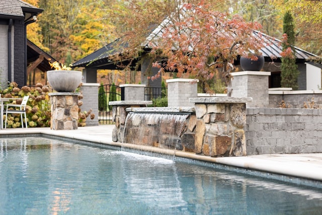 view of swimming pool featuring pool water feature