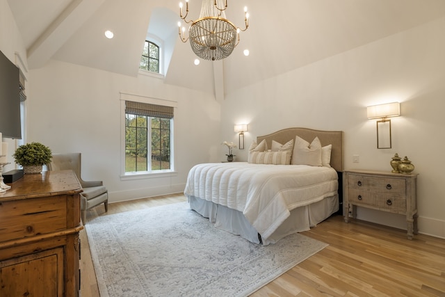 bedroom with light wood-type flooring, a notable chandelier, beamed ceiling, and high vaulted ceiling