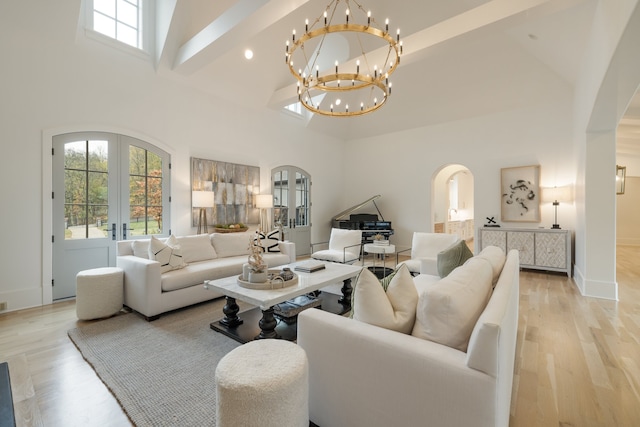 living room featuring french doors, high vaulted ceiling, and light wood-type flooring