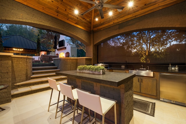 view of patio / terrace featuring an outdoor wet bar, a gazebo, area for grilling, and ceiling fan