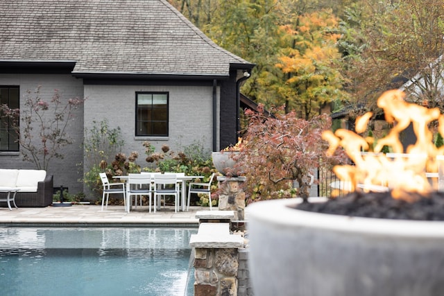 view of swimming pool with a patio and pool water feature