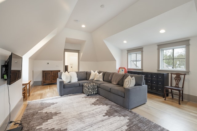 living room with vaulted ceiling and light hardwood / wood-style floors