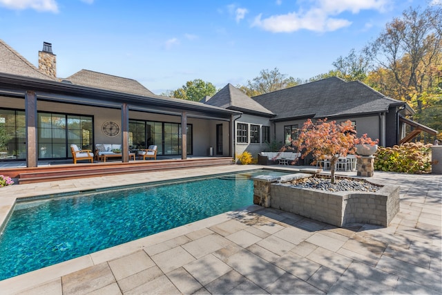 view of swimming pool with an in ground hot tub and a patio area