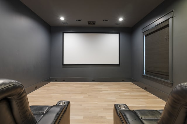 home theater room with light wood-type flooring