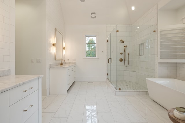 bathroom featuring vanity, lofted ceiling, and separate shower and tub