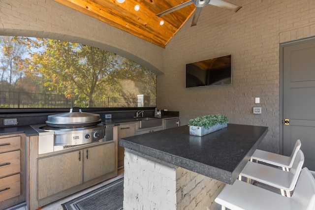 view of patio featuring an outdoor kitchen, ceiling fan, and sink