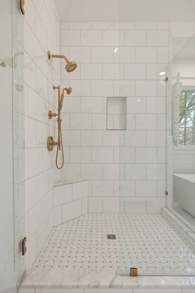 bathroom featuring a shower with shower door