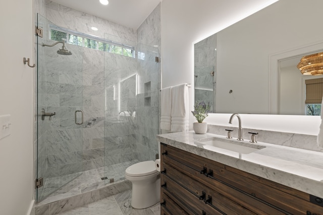 bathroom with vanity, toilet, and a shower with door