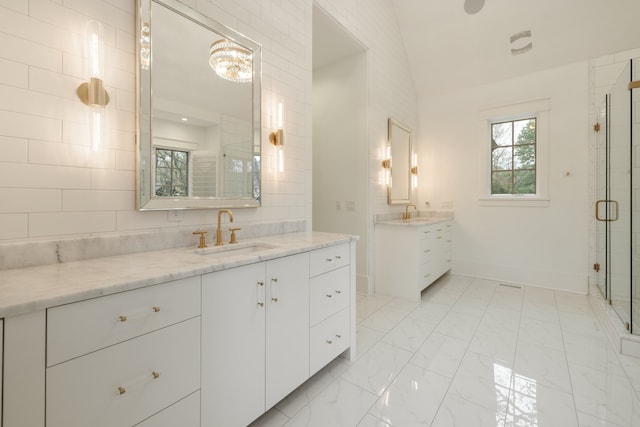 bathroom with an enclosed shower, vanity, and lofted ceiling