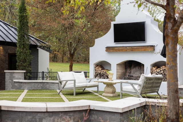 view of community featuring a lawn and a patio