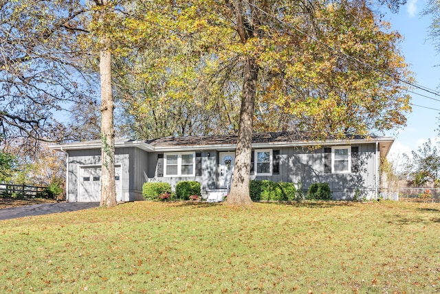 single story home featuring a garage and a front yard