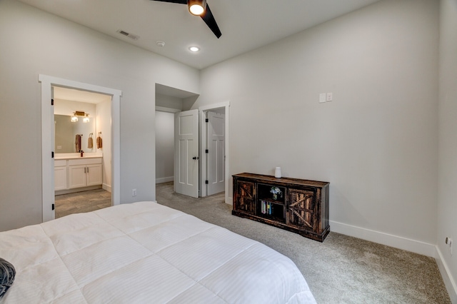 bedroom with carpet, ceiling fan, and connected bathroom