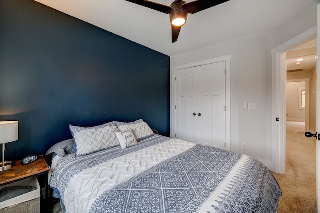 carpeted bedroom with a closet and ceiling fan