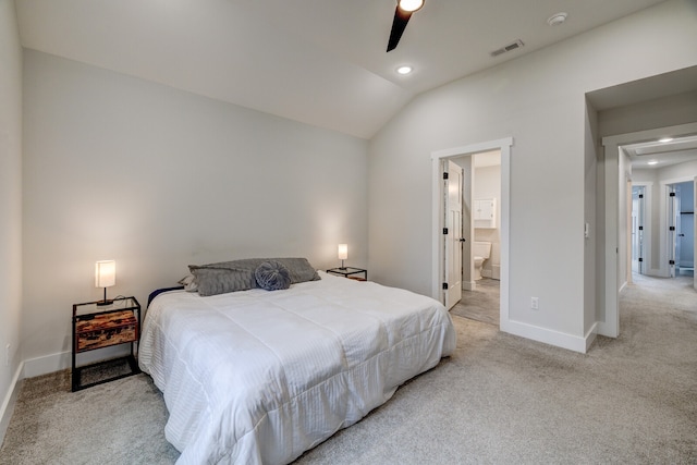 bedroom with light carpet, lofted ceiling, ceiling fan, and connected bathroom