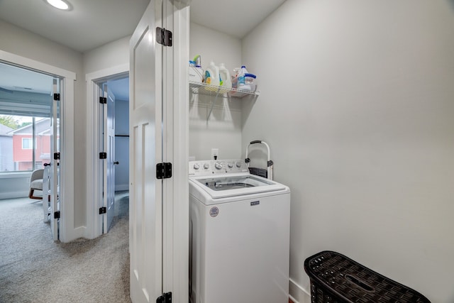 laundry area featuring washer / clothes dryer and light carpet