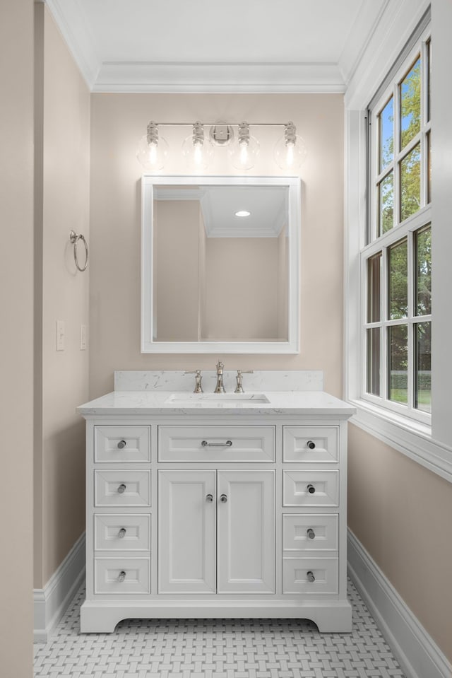 bathroom with vanity, a healthy amount of sunlight, and crown molding