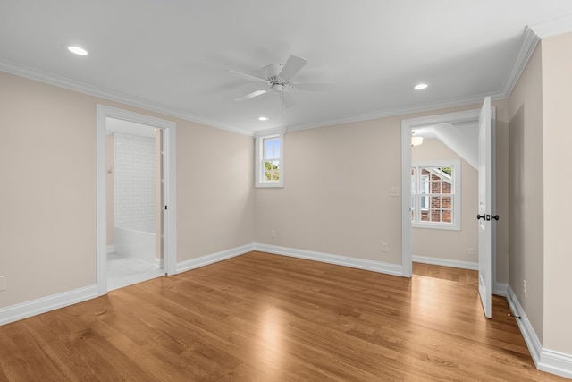 spare room with crown molding, plenty of natural light, light hardwood / wood-style floors, and ceiling fan