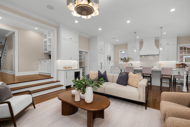 living room featuring hardwood / wood-style flooring and crown molding