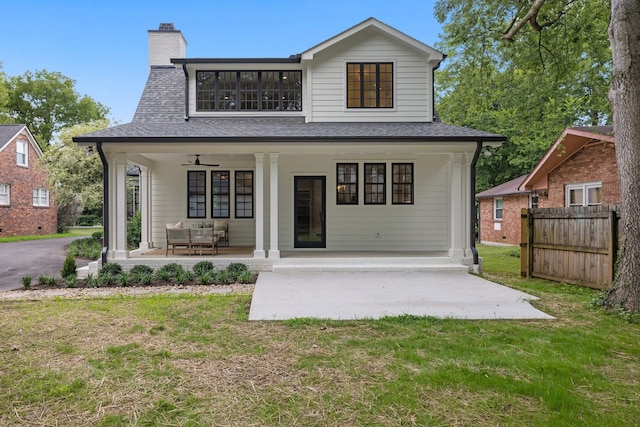 rear view of property featuring a patio, ceiling fan, and a lawn