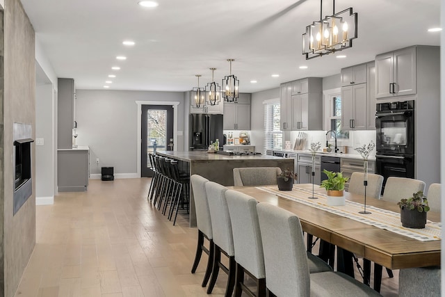 dining room featuring light wood-type flooring and sink