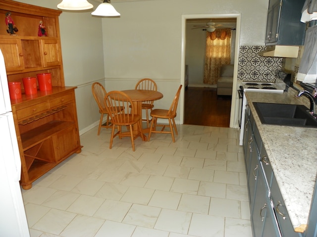 dining space with sink and ceiling fan