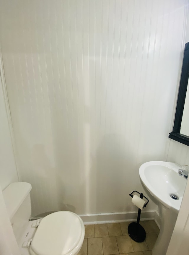 bathroom featuring toilet and tile patterned floors