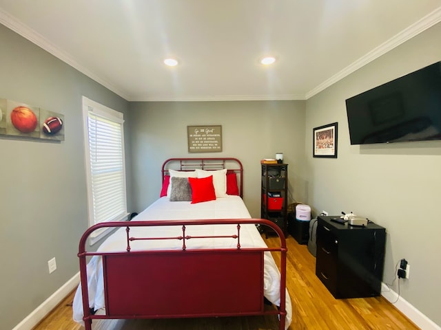 bedroom with light hardwood / wood-style flooring and crown molding