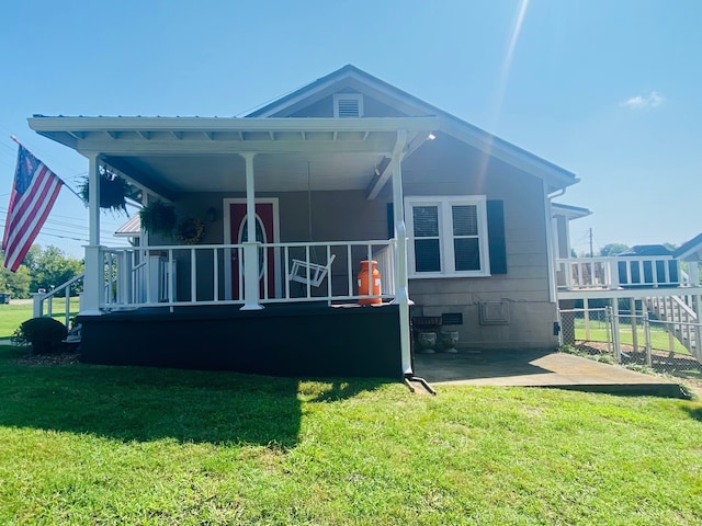 back of house with a lawn