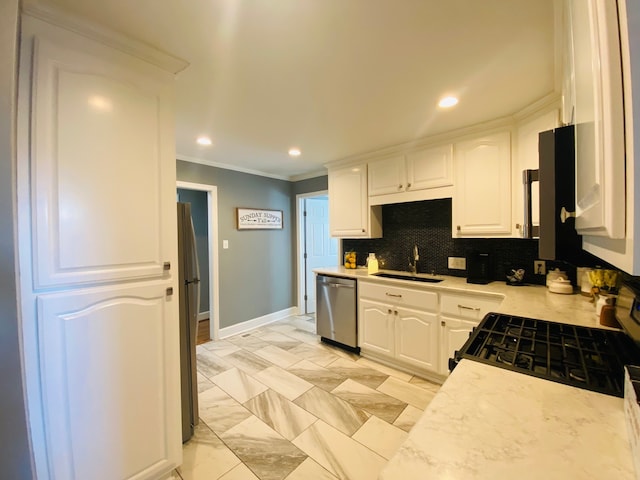 kitchen with white cabinets, sink, stainless steel appliances, and ornamental molding