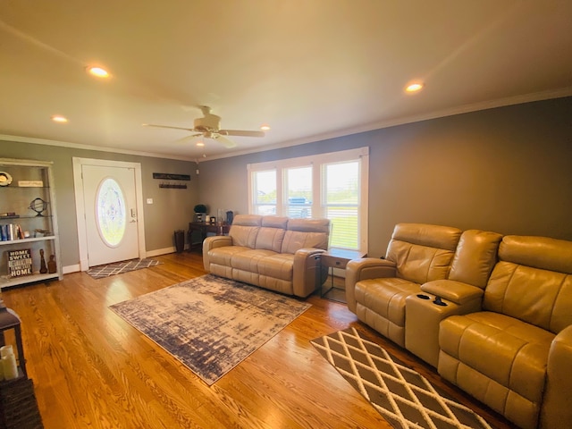 living room with hardwood / wood-style flooring, ceiling fan, and crown molding