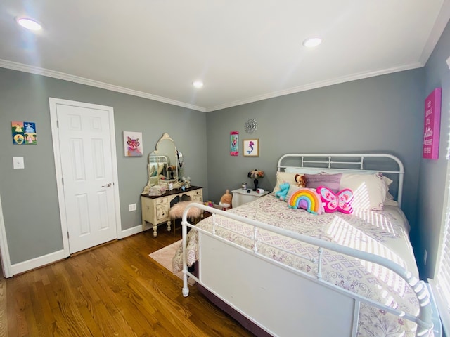 bedroom featuring ornamental molding and hardwood / wood-style floors