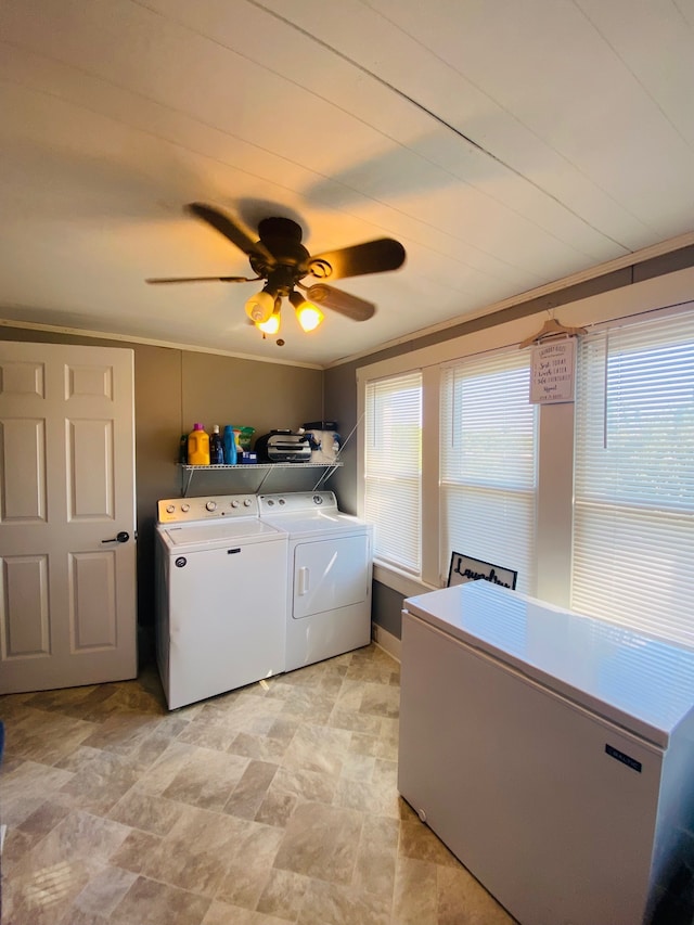 clothes washing area with washing machine and dryer, ceiling fan, and crown molding