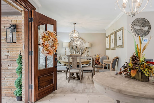 dining room featuring a chandelier, light hardwood / wood-style flooring, and ornamental molding