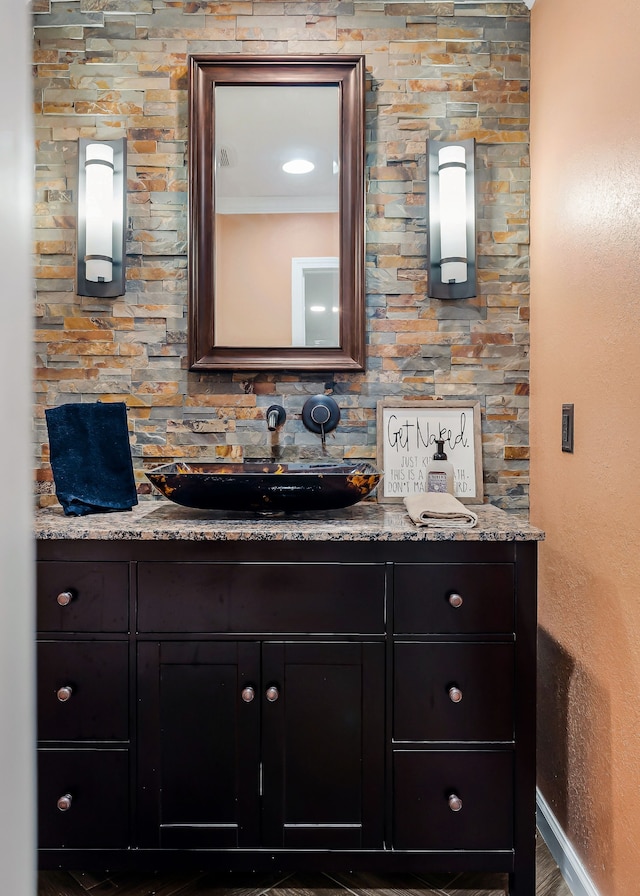 bathroom with vanity, wood-type flooring, and crown molding