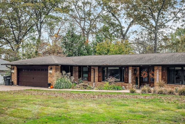 single story home featuring a garage and a front lawn